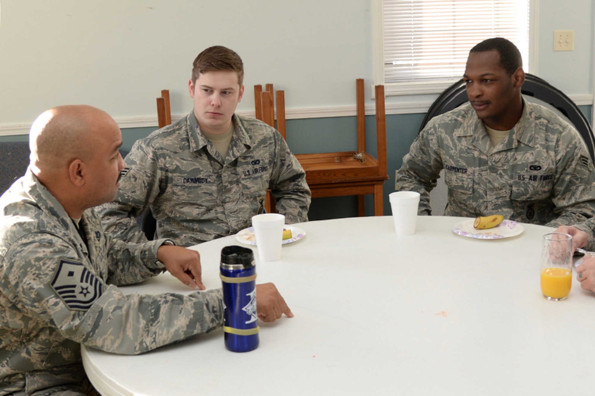 Master Sgt. Kevin C. Walker, 319th Recruiting Squadron first sergeant, speaks with Senior Airmen John T. Carmody, 6th Space Warning Squadron, and Brandon H. Carpenter, 66th Security Forces Squadron, during an Airman Leadership School and Top Three Breakfast at the Community Center, April 1. Senior NCOs were invited to mentor those E-4s scheduled to graduate from the five-week long course. (U.S. Air Force photo by Linda LaBonte Britt)