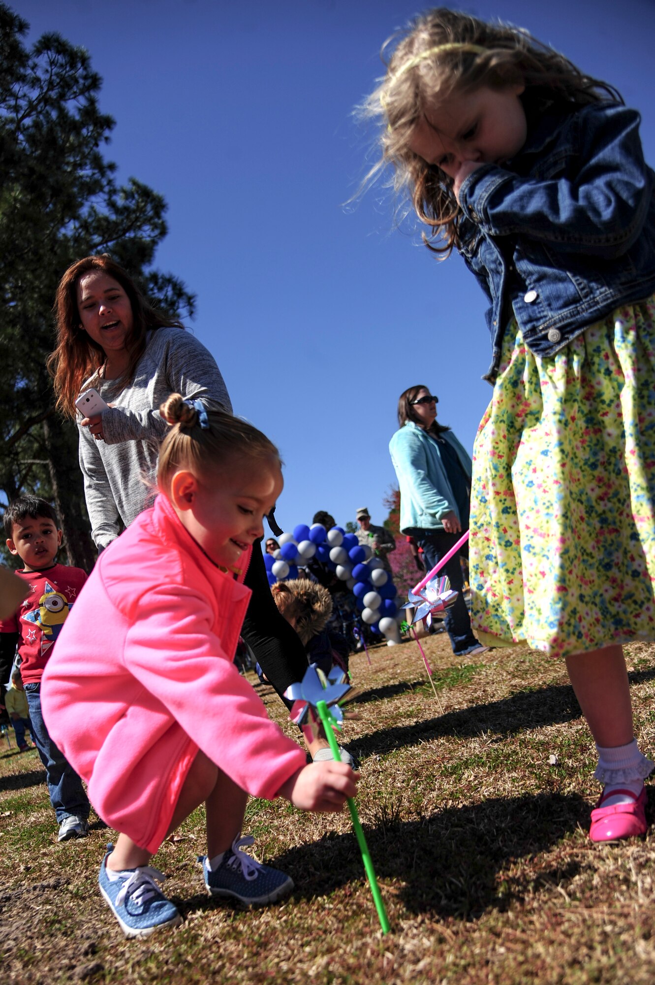 Children of Team Seymour plant pinwheels during a “Pinwheels for Child Abuse Prevention” event, April 1, 2015, at Seymour Johnson Air Force Base, North Carolina. Every April is recognized as Child Abuse Prevention Month and acknowledges the importance of families and communities working together to prevent child abuse and neglect. (U.S Air Force photo/Senior Airman Brittain Crolley)