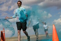 Team Malmstrom members run past the blue station of the Wingman Month kickoff color run April 1, 2015 at Malmstrom Air Force Base, Mont. The blue station, one of four set up around the 1.7 mile course, represented Child Abuse Prevention Month. (U.S. Air Force photo/Chris Willis)