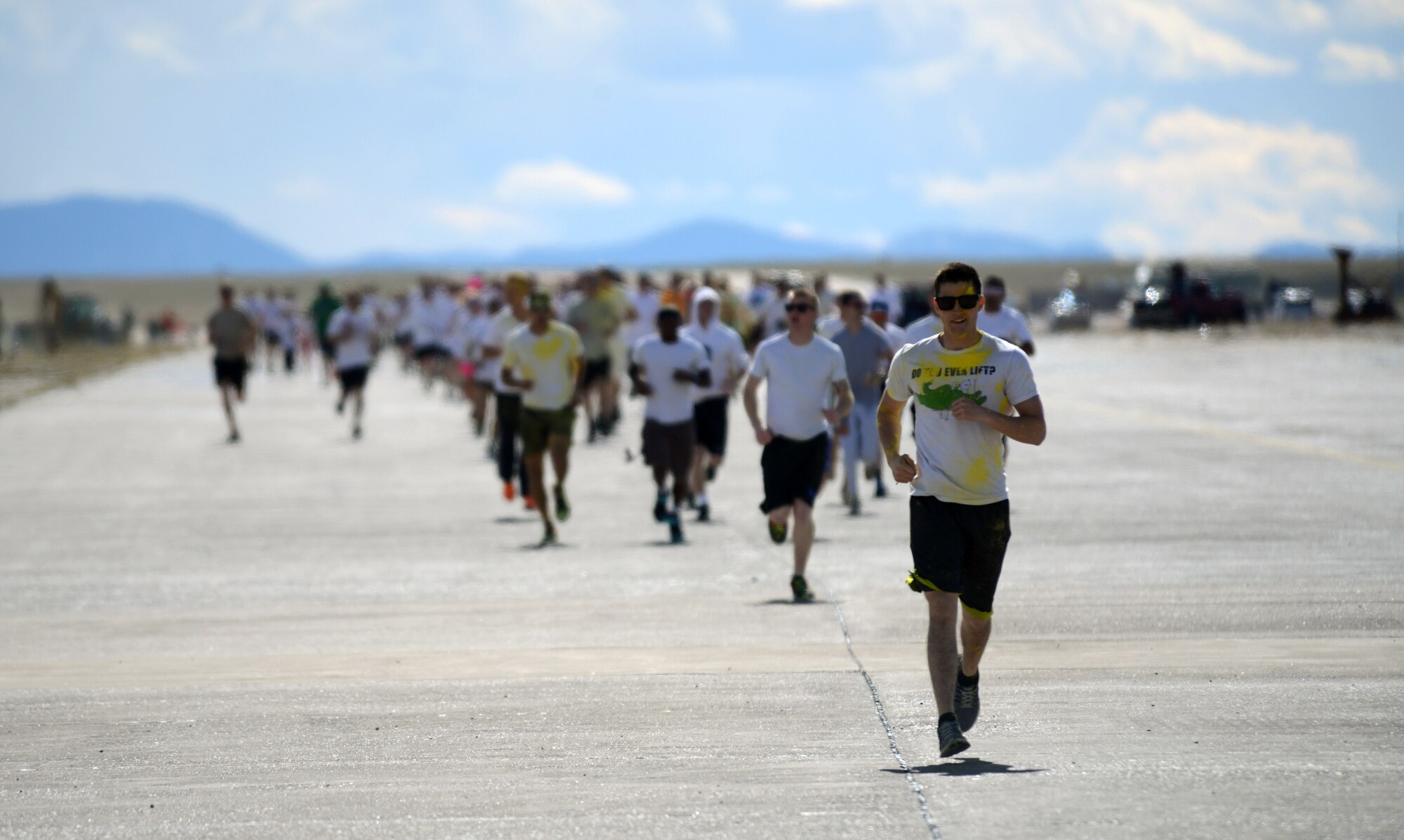 Team Malmstrom members run during the Wingman Month kickoff color run April 1, 2015, at Malmstrom Air Force Base, Mont. The run aimed to facilitate a fun and creative take on a wing run, with Airmen, their families and civilians taking part. (U.S. Air Force photo/Airman 1st Class Dillon Johnston)