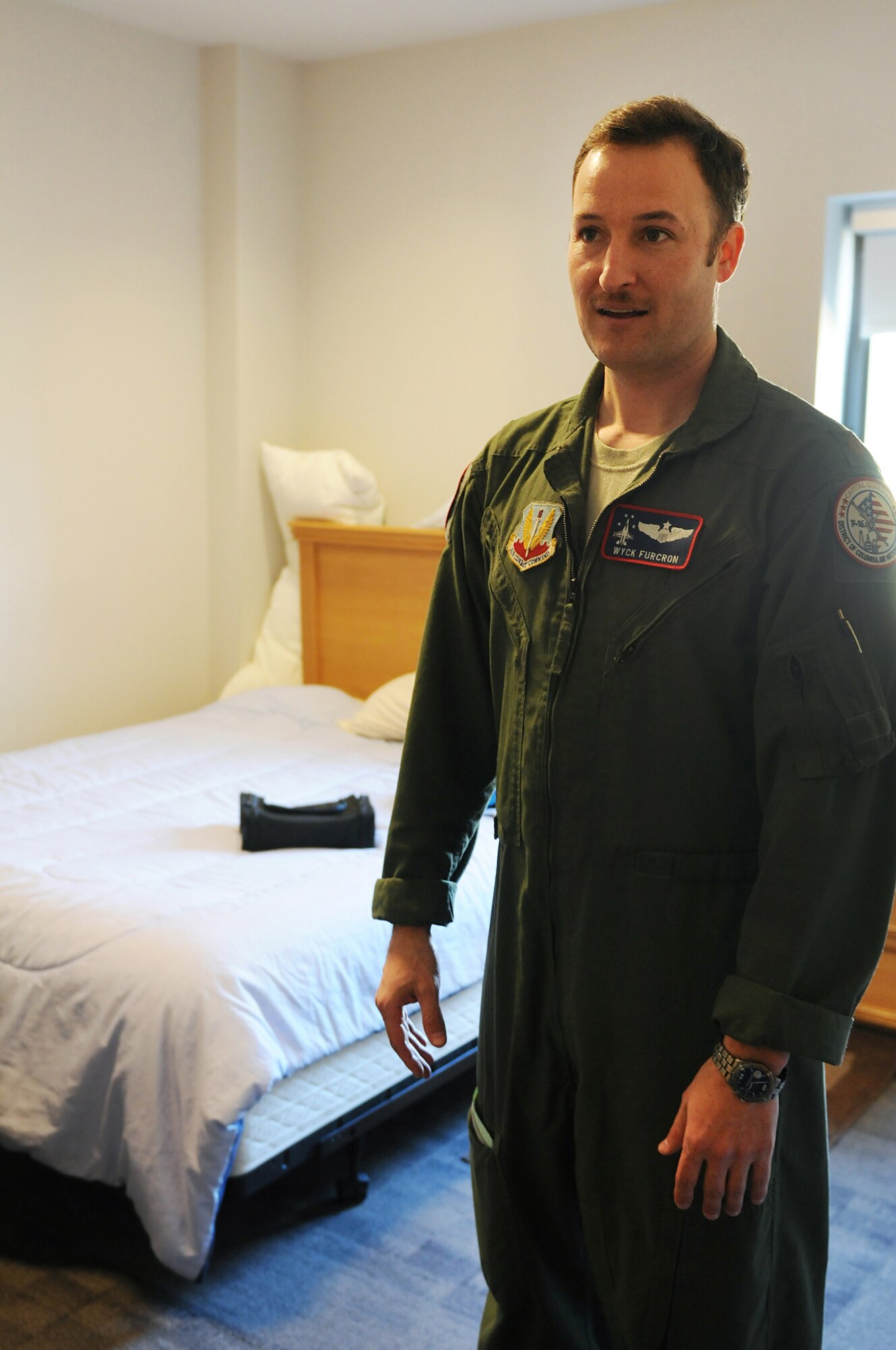 At the start of his 24 hour shift, pilot Maj. Wyck Furcron, with the 121st Fighter Squadron, drops his overnight bag in one of the many bedrooms located in the facility at the 113th Fighter Wing's Aerospace Control Alert Detachment, March 14, 2015. The D.C. Air National Guard’s F-16s and ready trained personnel are part of a multi-layered air defense system for the nation’s capital. (Air National Guard photo by Master Sgt. Becky Vanshur)