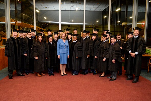 Secretary of the Air Force Deborah Lee James poses with the Ph.D. graduates from the Air Force Institute of Technology for a group photo prior to their graduation ceremony at the National Museum of the U.S. Air Force at Wright-Patterson Air Force Base March 26. James visited the school and was the keynote speaker for the graduation ceremony. (Air Force photo by Wesley Farnsworth) 

