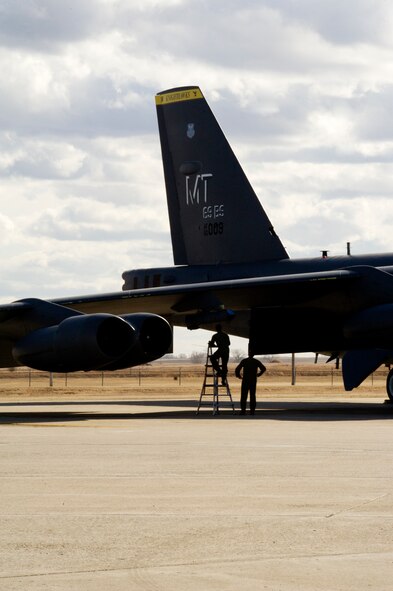 Aircrew members from the 69th Bomb Squadron perform a pre-flight check on a B-52H Stratofortress before take-off on Minot Air Force Base, N.D., April 1, 2014. The training mission, coined “POLAR GROWL”, aims to support bomber training requirements, ensuring global strike capabilities are flexible, credible and responsive to various threats.  (U.S. Air Force photo/Senior Airman Brittany Y. Bateman)