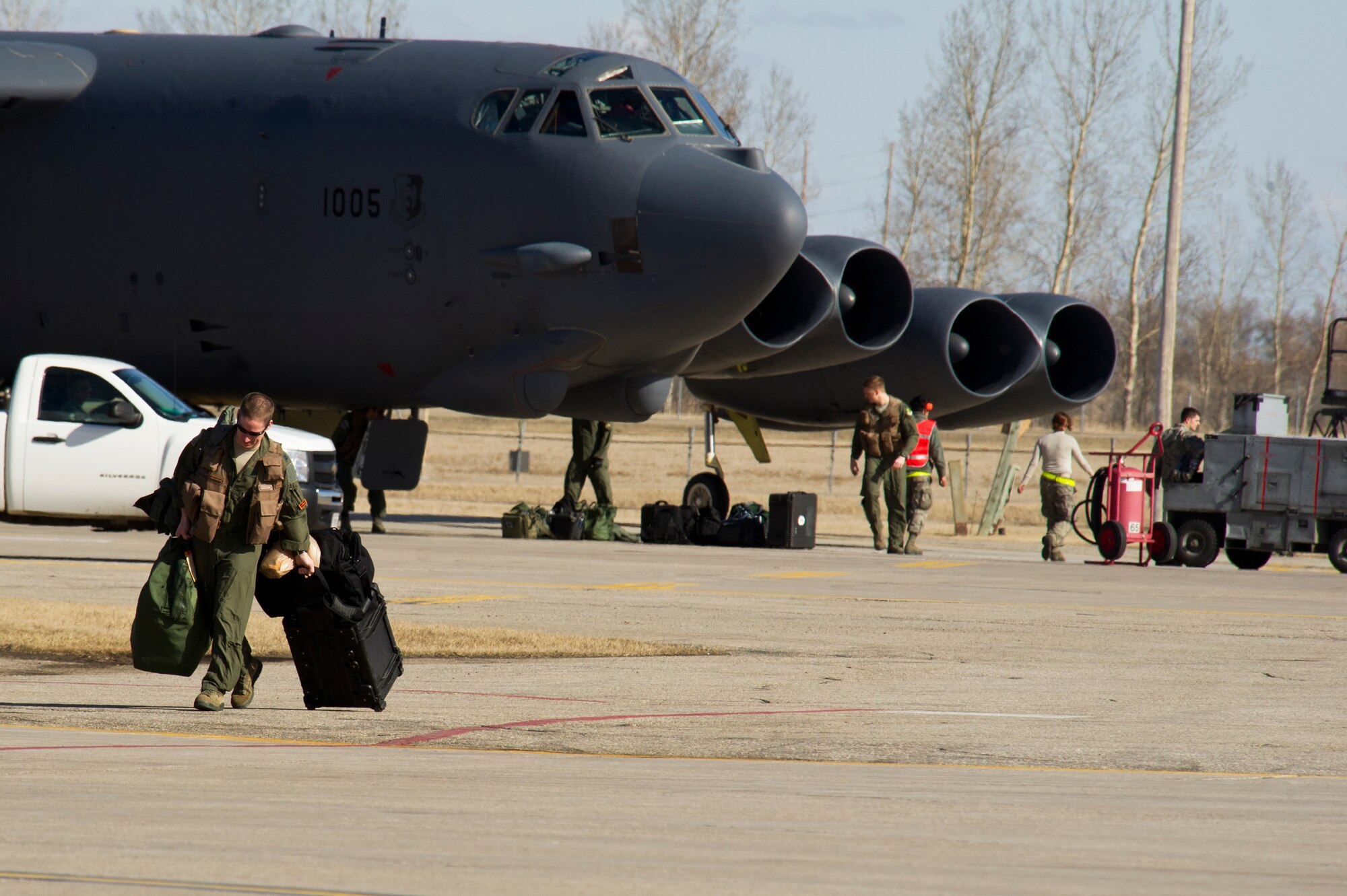 Aircrew members from the 23rd and 69th Bomb Squadron load their flight equipment on a B-52H Stratofortress before take-off on Minot Air Force Base, N.D., April 1, 2014. The training mission, coined “POLAR GROWL”, aims to support bomber training requirements, ensuring global strike capabilities are flexible, credible and responsive to various threats.  (U.S. Air Force photo/Senior Airman Brittany Y. Bateman)
