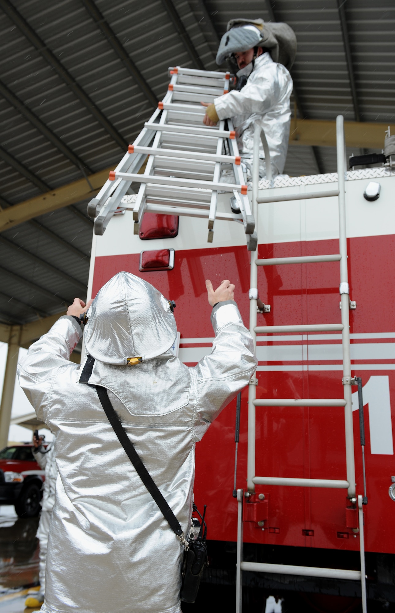 Firefighters from the 509th Civil Engineer Squadron prepare to evacuate a patient during egress training at Whiteman Air Force Base, Mo., March 18, 2015.  The training is on opening the aircraft canopy, shutting down the engine and safely removing aircrew members. (U.S. Air Force photo by Airman 1st Class Joel Pfiester/Released)