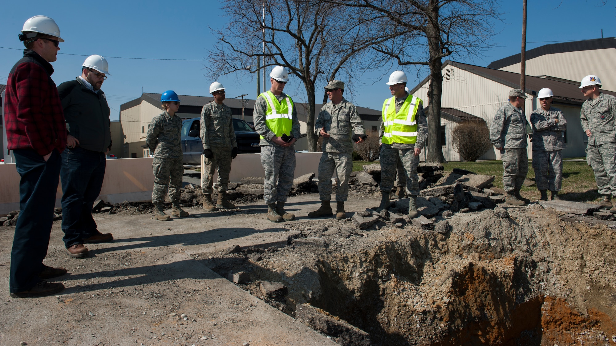 Tech. Sgt. Justin Hess, 436th Civil Engineer Squadron water-fuels maintenance, center, discusses an ongoing project with Col. Michael Grismer, 436th Airlift Wing commander, and Chief Master Sgt. Stanley Cadell, 436th AW command chief, April 1, 2015, at a work site on Dover Air Force Base, Del. The Airmen were conducting repairs to fire suppression piping for a nearby aircraft hangar. (U.S. Air Force photo/Airman 1st Class Zachary Cacicia) 