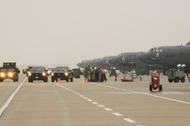 Airmen from the 5th Maintenance Group load weapons on a B-52H Stratofortress while Airmen from the 5th Security Forces Squadron provide security during an exercise on Minot Air Force Base, N.D., March 24, 2015. Air Force Global Strike Command routinely conducts training operations and exercises to ensure its forces can perform their mission when called upon at any time. (U.S. Air Force photo/Senior Airman Brittany Y. Bateman)