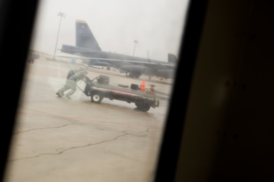 Airmen from the 5th Aircraft Maintenance Squadron push a piece of equipment on the flightline during an exercise on Minot Air Force Base, N.D., March 24, 2015. Exercises like these are integral to maintaining mission readiness. (U.S. Air Force photo/Senior Airman Brittany Y. Bateman) 