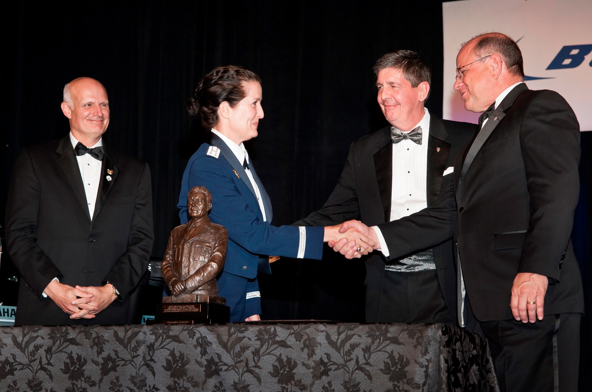 Maj. Gen. (Sel) Nina Armagno, 45th Space Wing commander, is congratulated for  receiving the Gen. Jerome F. O’Malley Distinguished Space Leadership Award by Scott Van Cleef, National Air Force Association Chairman of the Board, far right, Don Kidd, Air Force Association Lance P. Sijan Chapter president, second from the right, and retired Maj. Gen. Roger Burg, left, who helped present the O’Malley Award on behalf of his wife Sharon O’Malley-Burg, daughter of Gen. Jerome F. O'Malley, in Colorado Springs, Colo., March 20, 2015. (Courtesy photo by Allison Earnest) (Released) 