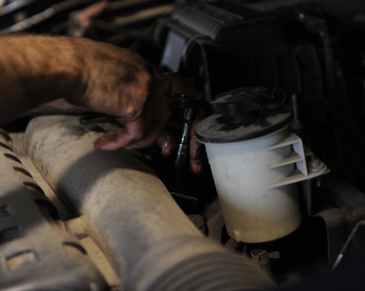 Lucas Griffore, 5th Logistics Readiness Squadron vehicle maintenance technician, changes a belt on a government-operated vehicle on Minot Air Force Base, N.D., April 2, 2015. Despite the high miles and age of the vehicles, most are in decent condition and only come in for routine maintenance. (U.S. Air Force photo/Senior Airman Kristoffer Kaubisch)