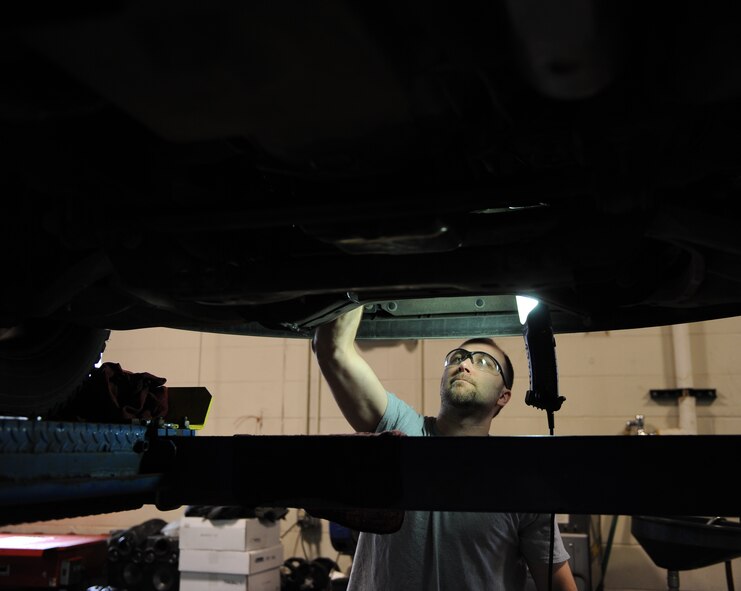 Lucas Griffore, 5th Logistics Readiness Squadron vehicle maintenance technician, changes a power steering line on a government-operated vehicle on Minot Air Force Base, N.D., April 2, 2015. The 5th LRS vehicle maintenance shop is responsible for the maintenance of all government-owned vehicles on base. (U.S. Air Force photo/Senior Airman Kristoffer Kaubisch)