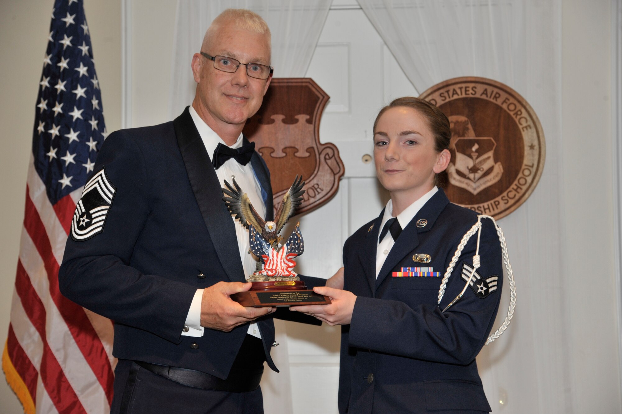 U.S. Air Force Senior Airman Katherine Nee, 3rd Intelligence Squadron, receives the John L. Levitow Award for the Senior Master Sgt. David B. Reid Airman Leadership School Class 15-3, from Chief Master Sgt. Scott Thomsen, 20th Operations Group superintendent, at Shaw Air Force Base, S.C., April 2, 2015. The Levitow Award is given to the graduate with the highest average of instructor and student points, and is the highest award in enlisted professional military education. (U.S. Air Force photo by Senior Airman Jonathan Bass/Released)