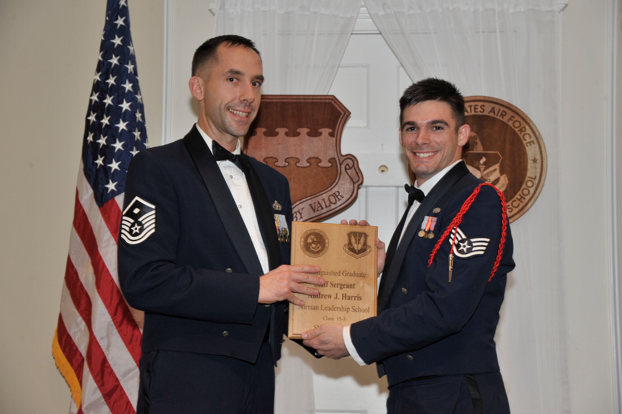 U.S. Air Force Staff Sgt. Andrew Harris, 31st Intelligence Squadron, receives a distinguished graduate award for the Senior Master Sgt. David B. Reid Airman Leadership School Class 15-3 from Master Sgt. Robert Finton, 20th Operations Support Squadron first sergeant, at Shaw Air Force Base, S.C., April 2, 2015. The distinguished graduate awards are given to the top 10 percent of the class for total point accumulation. (U.S. Air Force photo by Senior Airman Jonathan Bass/Released)