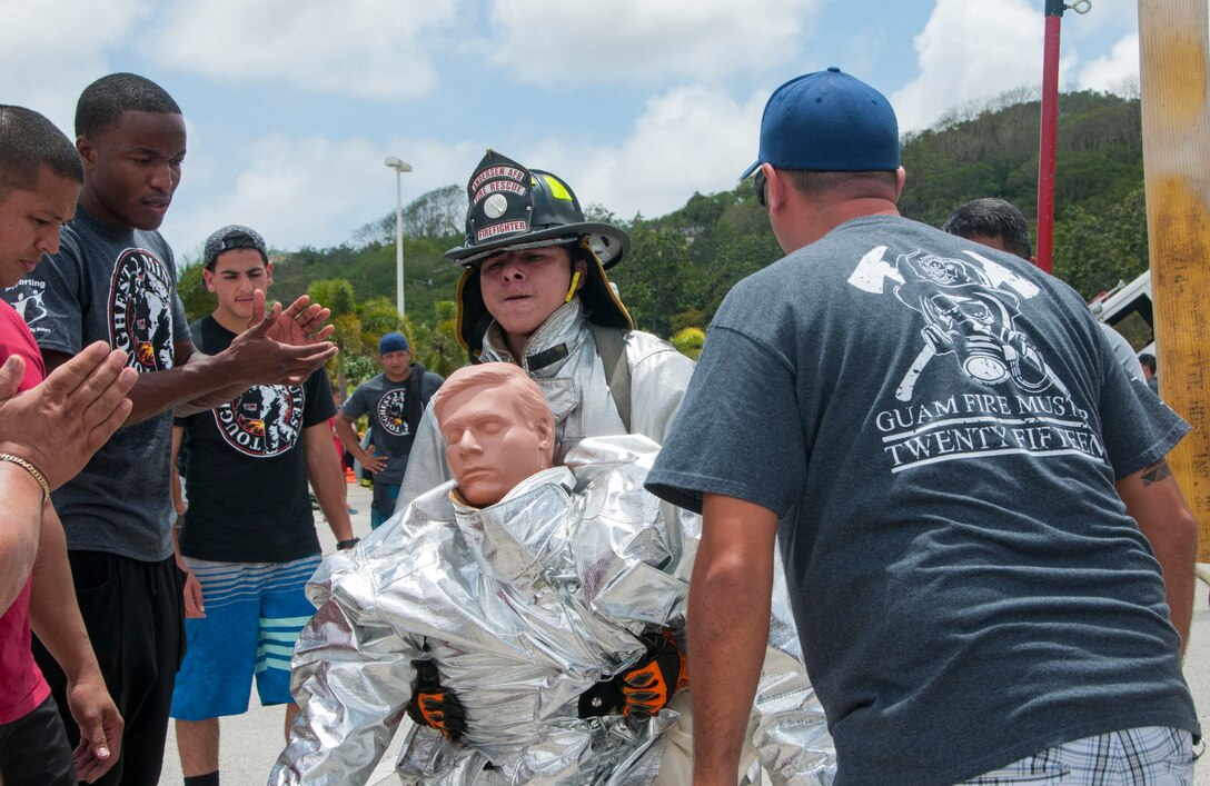 An Andersen Air Force Base firefighter carries a dummy during the 2015 Firefighter Muster and Competition in Hagatna March 28. The goal of the event was to promote camaraderie and trust in order to strengthen partnerships between all fire departments on Guam. (U.S. Navy photo by Leah Eclavea/Released)