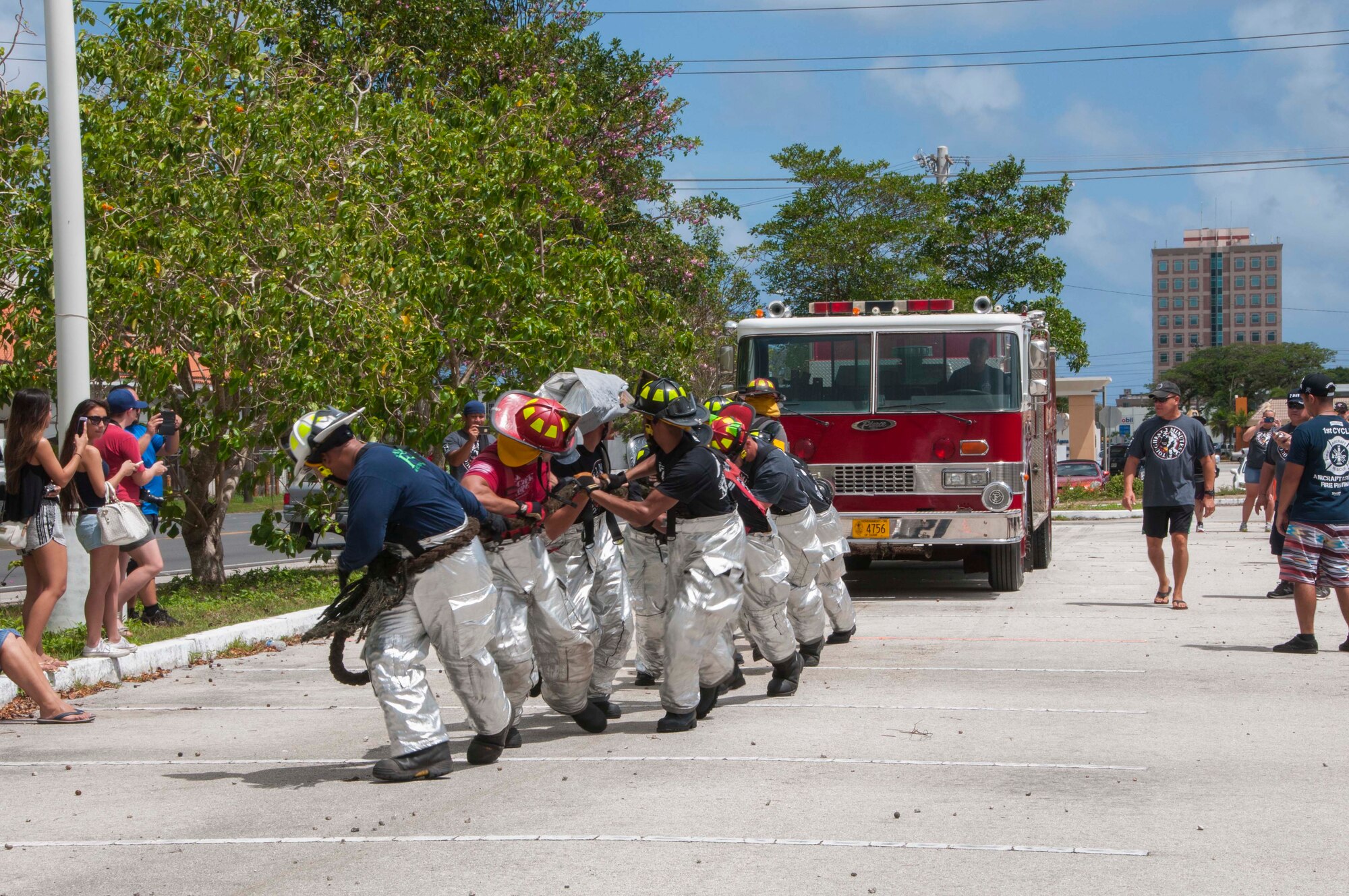 Andersen Air Force Base firefighters pull a fire truck during the 2015 Firefighter Muster and Competition in Hagatna March 28. The goal of the event was to promote camaraderie and trust in order to strengthen partnerships between all fire departments on Guam. (U.S. Navy photo by Leah Eclavea/Released)