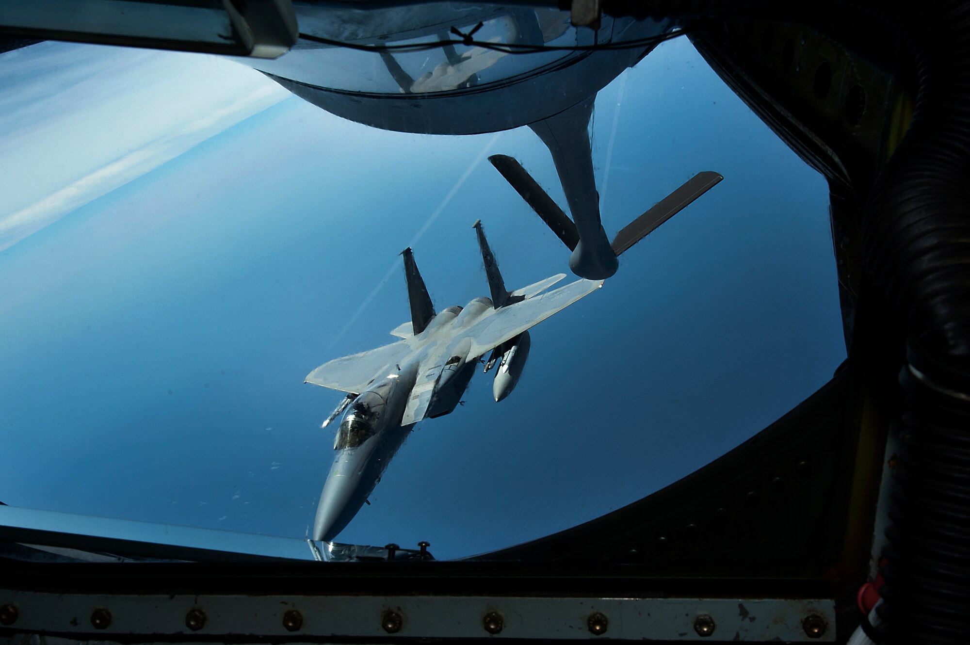 A U.S. Air Force F-15C Eagle stationed at Kadena Air Base, Japan, departs from a 909th Air Refueling Squadron KC-135 Stratotanker after being refueled during  the Forceful Tiger exercise near Okinawa, Japan, April 1, 2015. The Stratotankers allowed approximately 50 aircraft to stay airborne during the exercise for more than four hours by keeping them fueled. (U.S. Air Force photo by Airman 1st Class Zackary A. Henry)