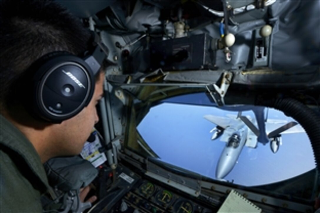 U.S. Air Force Staff Sgt. Chance Italiano moves the refueling boom from a KC-135 Stratotanker aircraft into position to refuel a U.S. Air Force F-15C Eagle during Exercise Forceful Tiger near Okinawa, Japan, April 1, 2015. Italiano is a boom operator assigned to the 909th Air Refueling Squadron.