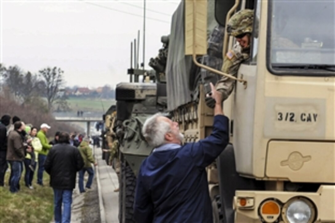 A resident greets a U.S. soldier as the Army contingent crosses into the Czech Republic from Poland during the capstone training event for Operation Atlantic Resolve North, March 29, 2015. 