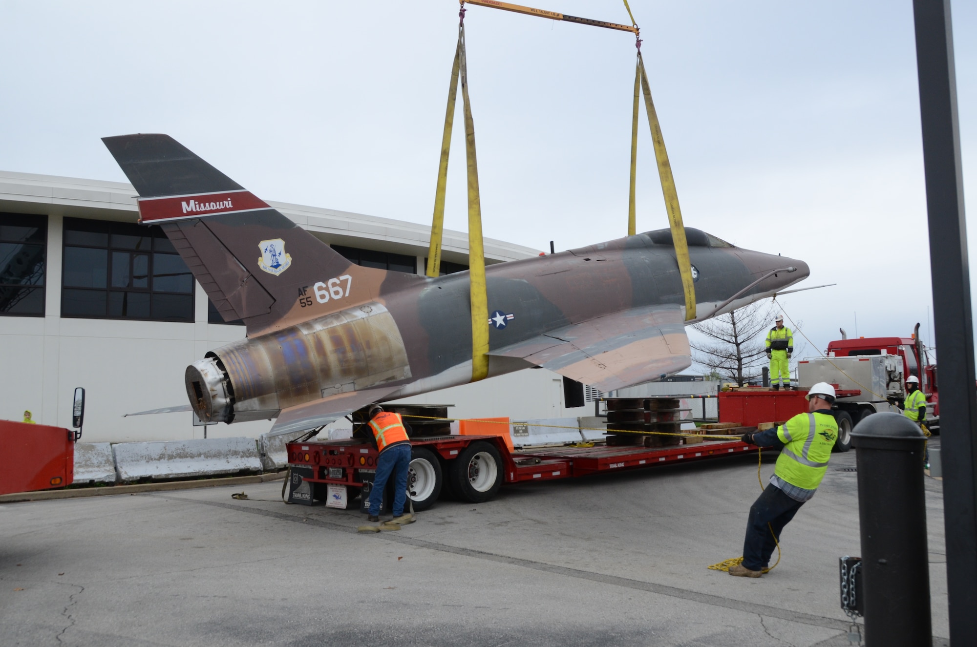 An F-100 Super Sabre jet (AF55-667) on static display at the Missouri Air National Guard’s 131st Bomb Wing base at Lambert-St. Louis International Airport, is removed from its pedestal, April 3, 2015. A total of three static display aircraft, including an F-15A Eagle and an F-4 Phantom II, will be transported to a new home at the planned 131st Bomb Wing Heritage Park at Whiteman Air Force Base, Mo. (U.S. Air National Guard photo by Senior Master Sgt. Mary-Dale Amison)