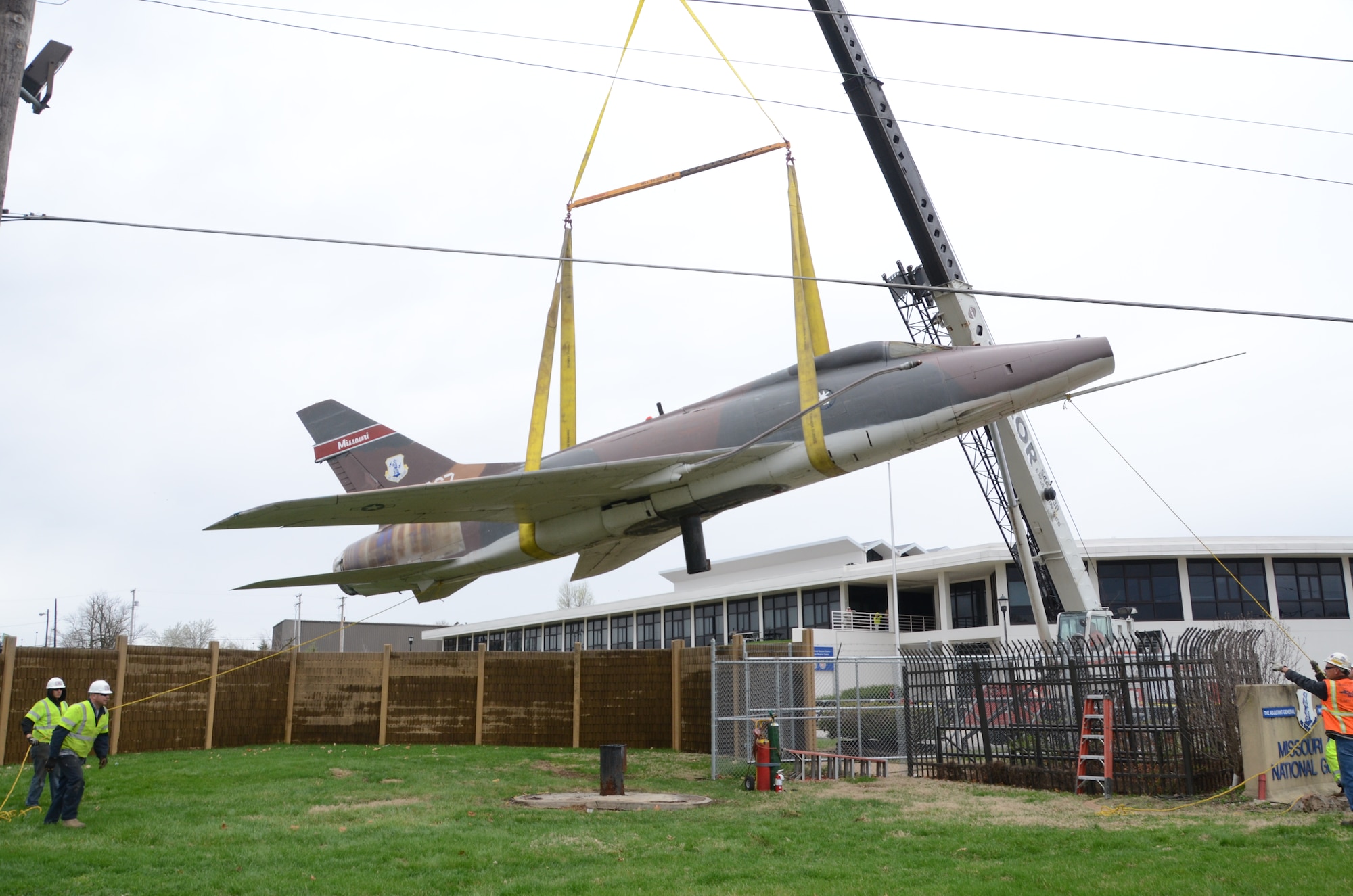 An F-100 Super Sabre jet (AF55-667) on static display at the Missouri Air National Guard’s 131st Bomb Wing base at Lambert-St. Louis International Airport, is removed from its pedestal, April 3, 2015. A total of three static display aircraft, including an F-15A Eagle and an F-4 Phantom II, will be transported to a new home at the planned 131st Bomb Wing Heritage Park at Whiteman Air Force Base, Mo. (U.S. Air National Guard photo by Senior Master Sgt. Mary-Dale Amison)