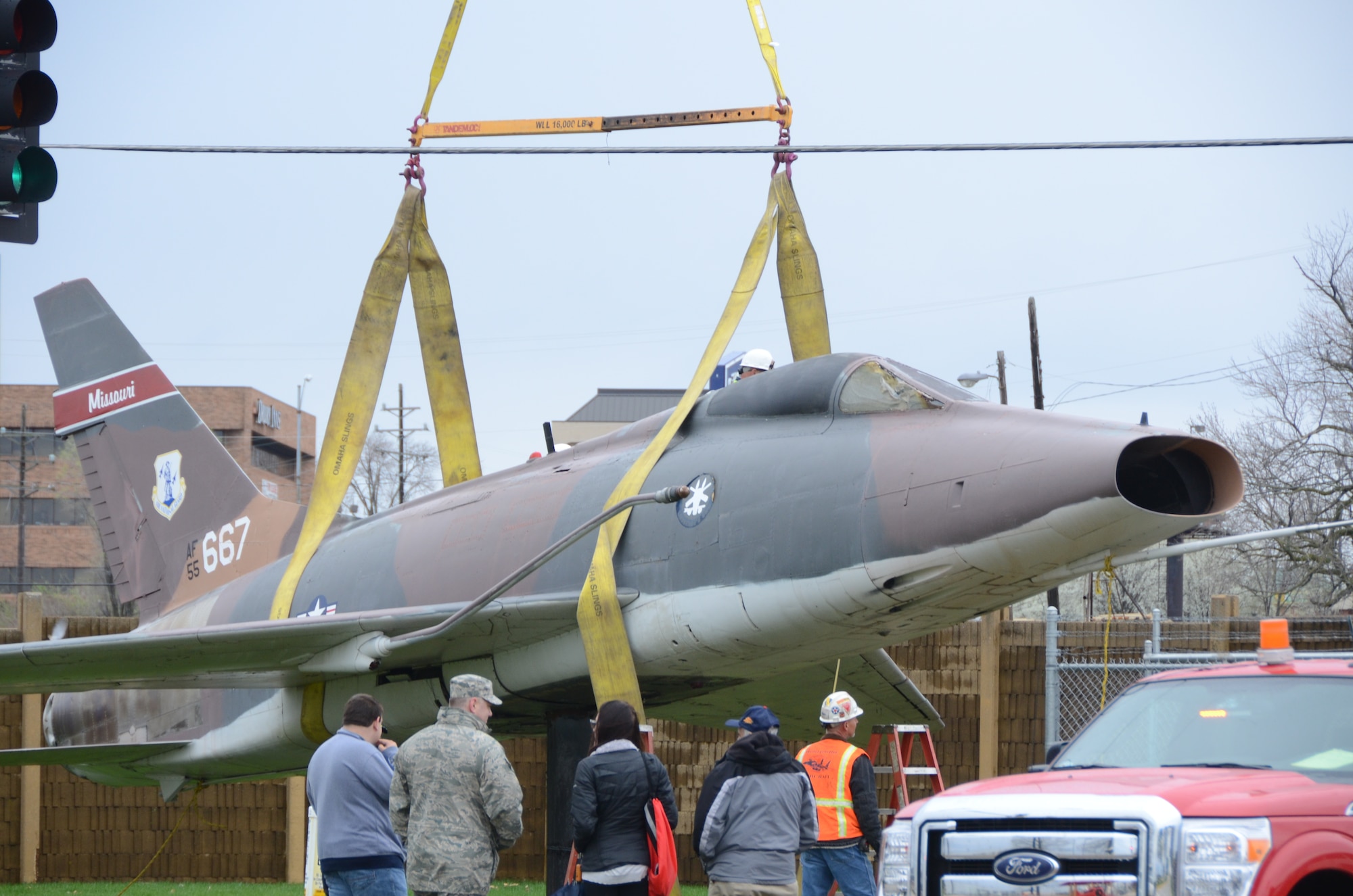 An F-100 Super Sabre jet (AF55-667) on static display at the Missouri Air National Guard’s 131st Bomb Wing base at Lambert-St. Louis International Airport, is removed from its pedestal, April 3, 2015. A total of three static display aircraft, including an F-15A Eagle and an F-4 Phantom II, will be transported to a new home at the planned 131st Bomb Wing Heritage Park at Whiteman Air Force Base, Mo. (U.S. Air National Guard photo by Senior Master Sgt. Mary-Dale Amison)