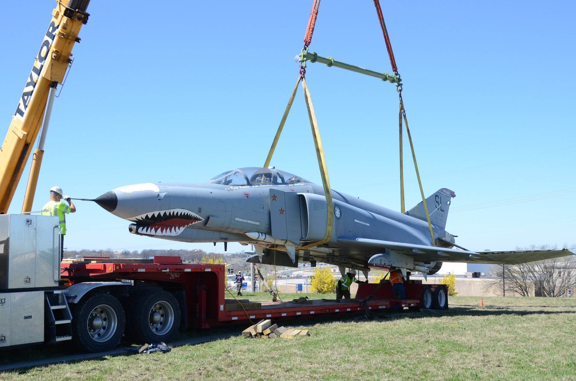 An F-4 Phantom II jet (AF68-338) on static display at the Missouri Air National Guard’s 131st Bomb Wing base at Lambert-St. Louis International Airport, is removed from its pedestal, March 31, 2015. A total of three static display aircraft, including an F-15A Eagle and an F-100 Super Sabre, will be transported to a new home at the planned 131st Bomb Wing Heritage Park at Whiteman Air Force Base, Mo. (U.S. Air National Guard photo by Senior Master Sgt. Mary-Dale Amison)