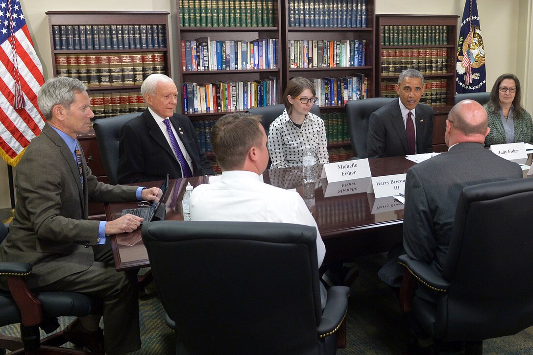 President Barack Obama, center right, speaks with U.S. Sen. Orrin Hatch, second from left, Harry Briesmaster III, second from right, director of the 75th Civil Engineer Group, and Utah community leaders on Hill Air Force Base in Davis County, Utah, about Hill’s clean and renewable energy programs, April 3, 2015.