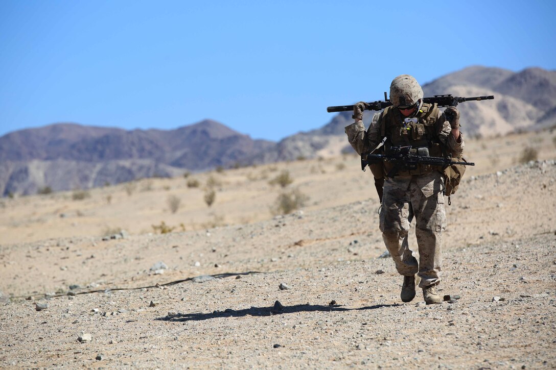 Cpl. Joshua S. Baczkowski, machine gunner, Machine Gun Section, Weapons Company, Ground Combat Element Integrated Task Force, carries an M240B machine gun during a Marine Corps Operational Test and Evaluation Activity assessment at Range 107, Marine Corps Air Ground Combat Center Twentynine Palms, California, March 30, 2015. From October 2014 to July 2015, the GCEITF will conduct individual and collective level skills training in designated ground combat arms occupational specialties in order to facilitate the standards-based assessment of the physical performance of Marines in a simulated operating environment performing specific ground combat arms tasks. (U.S. Marine Corps photo by Cpl. Paul S. Martinez/Released)