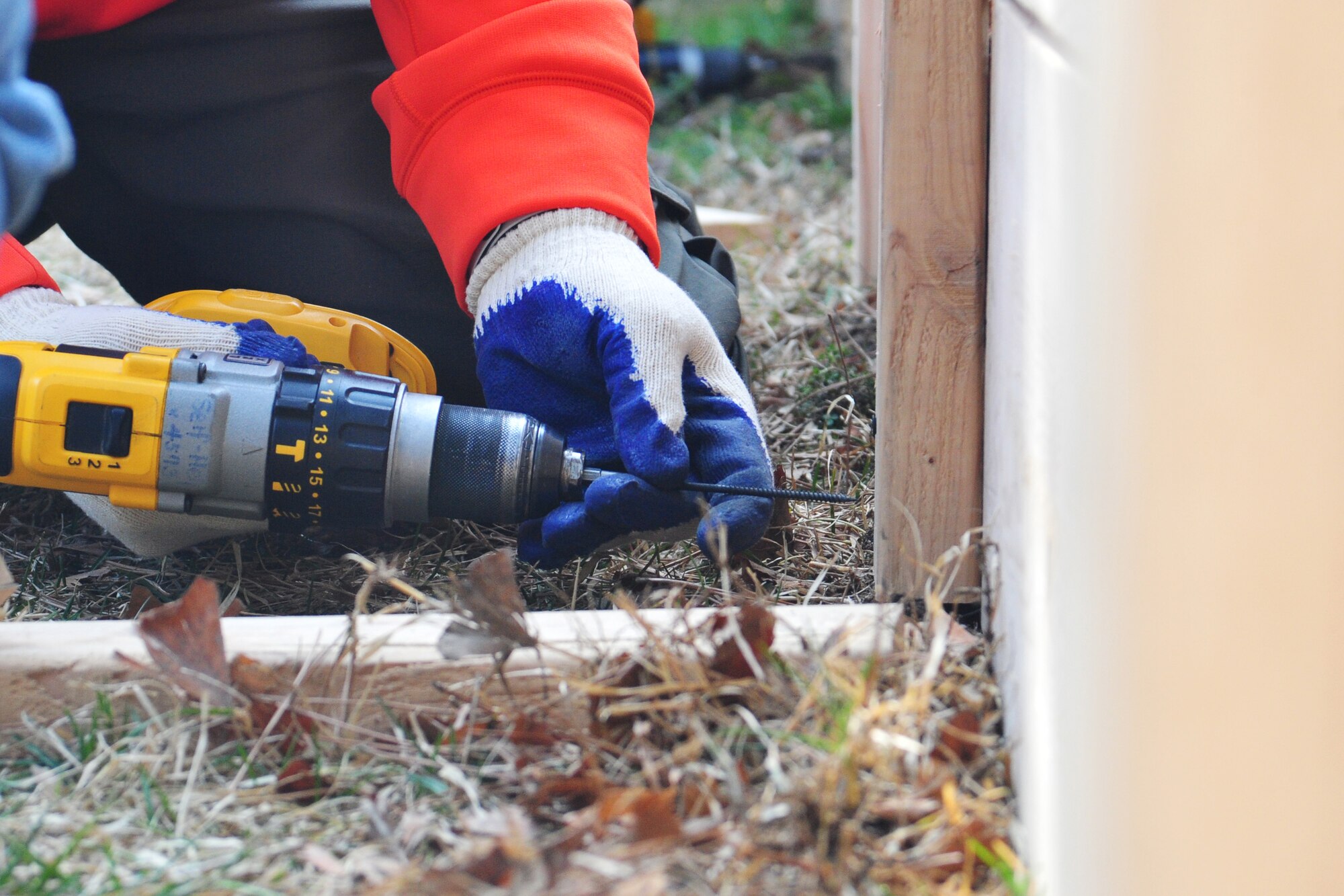 An 8th Fighter Wing Airman reinforces the retaining wall of “Wolf Pack Garden” in front of the Sonlight Inn, March 14, 2015, at Kunsan Air Base, Republic of Korea. The garden is part of a community initiative to promote healthy living for Wolf Pack Airmen. (U.S. Air Force photo by Tech. Sgt. George Maddon/Released)
