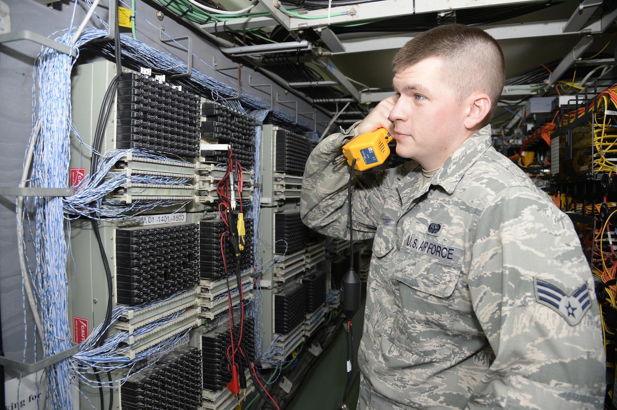 Senior Airman Christopher, client service technician, tests a new telephone line at an undisclosed location in Southwest Asia March 30, 2015. During their rotation CST Airmen have worked approximately 2,200 tickets and currently assist up to 150 customers a day with new account requests in addition to handling computer and telephone issues. Christopher is currently deployed from Mountain Home Air Force Base, Idaho. (U.S. Air Force photo/Tech. Sgt. Marie Brown/RELEASED)