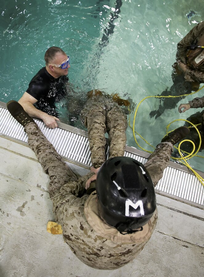 Marines and Sailors with the 26th Marine Expeditionary Unit practice using respirators during underwater egress training at the Water Survival Training Center aboard Marine Corps Base Camp Lejeune, N. C., March 24, 2015. Marines and Sailors with the 26th MEU are required to complete the training in order to ensure safety and maintain readiness for future deployments. (U.S Marine Corps photo by Pfc. Dalton A. Precht/Released)