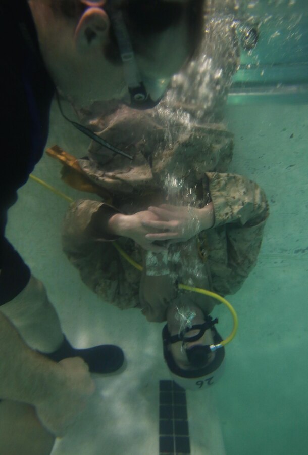A Marine with the 26th Marine Expeditionary Unit practices using a respirator during underwater egress training at the Water Survival Training Center aboard Marine Corps Base Camp Lejeune, N. C., March 24, 2015. Marines and Sailors with the 26th MEU are required to complete the training in order to ensure safety and maintain readiness for future deployments. (U.S Marine Corps photo by Pfc. Dalton A. Precht/Released)