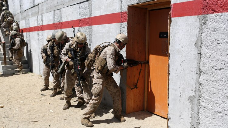 Marines with Charlie Company, 1st Reconnaissance Battalion, wait in file before breaching a door during a live-fire raid at Range 226 aboard Camp Pendleton, Calif., April 1, 2015. The company conducted the live-fire exercise as part of a predeployment workup in support of the 13th Marine Expeditionary Unit. 