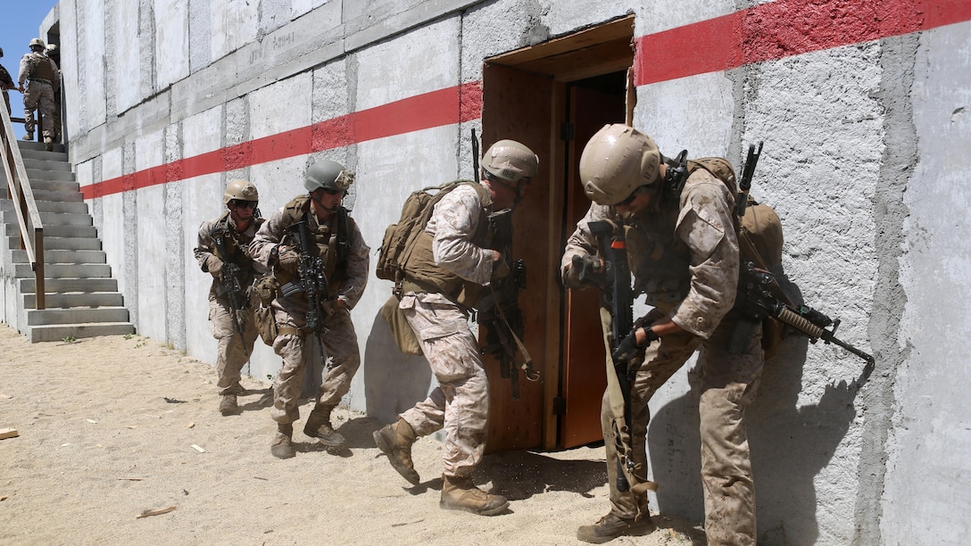 Marines with Charlie Company, 1st Reconnaissance Battalion, rush into a compound after breaching a door during a live-fire raid at Range 226 aboard Camp Pendleton, Calif., April 1, 2015. The company conducted the live-fire exercise as part of a predeployment workup in support of the 13th Marine Expeditionary Unit.