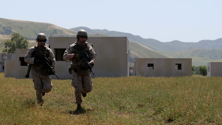 Marines with Charlie Company, 1st Reconnaissance Battalion, sprint across a field during a live-fire raid at Range 226 aboard Camp Pendleton, Calif., April 1, 2015. The company conducted the live-fire exercise as part of a predeployment workup in support of the 13th Marine Expeditionary Unit. 