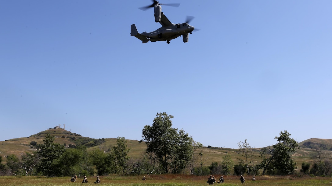 Marines with Charlie Company, 1st Reconnaissance Battalion, await extraction in a field during a live-fire raid at Range 226 aboard Camp Pendleton, Calif., April 1, 2015. The company conducted the live-fire exercise as part of a predeployment workup in support of the 13th Marine Expeditionary Unit. 