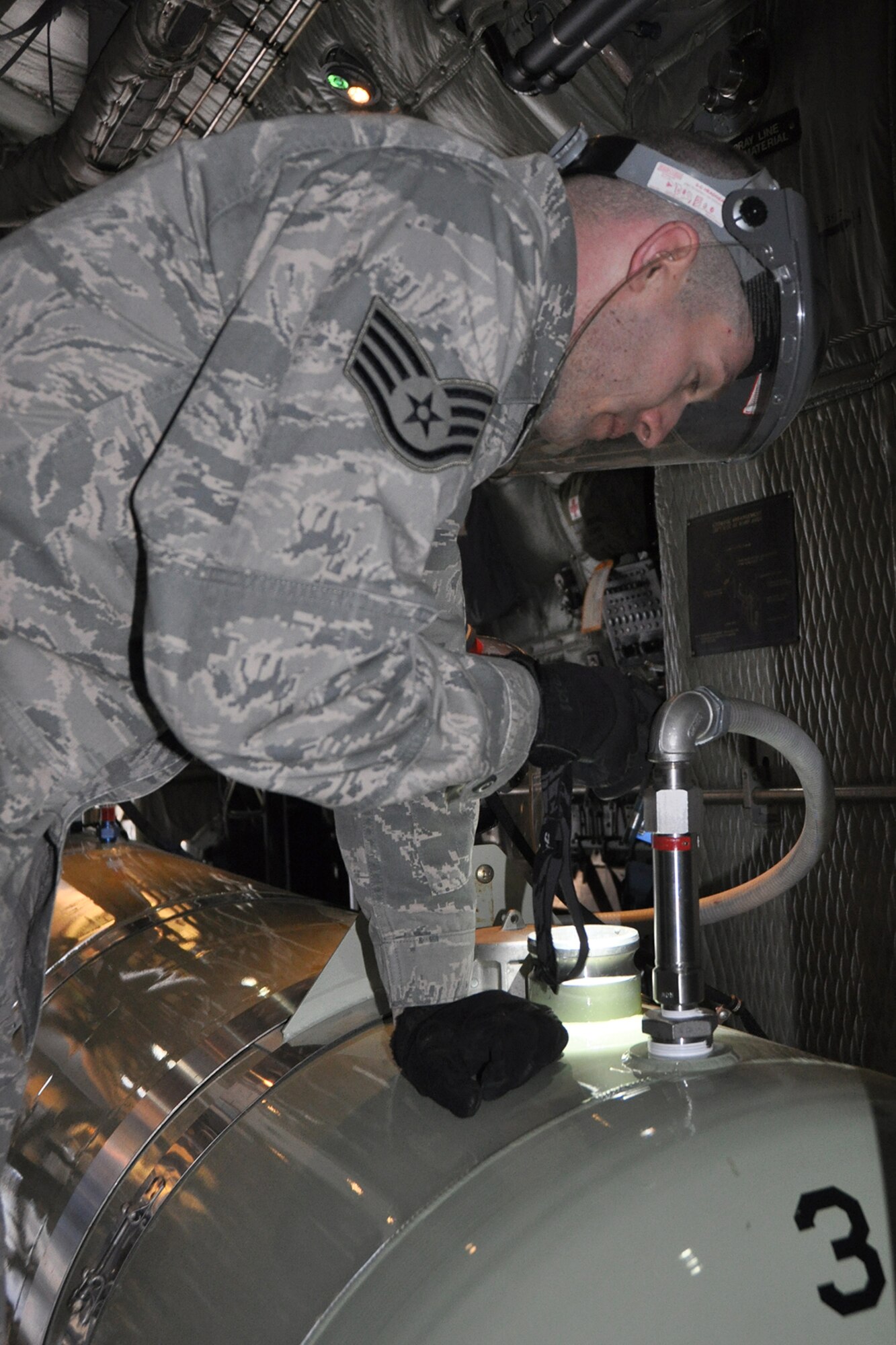 Air Force Reserve Staff Sgt. Thaddeus Root, a 910th Airlift Wing Aerial Spray Maintainer, checks the contents in a tank of the Modular Aerial Spray System (MASS) on the cargo deck aboard a modified C-130H Hercules tactical cargo aircraft, assigned to the 910th based at Youngstown Air Reserve Station, Ohio, on the flightline here in preparation for an aerial spray sortie, March 17, 2015. Root and other members of the 910th’s Aerial Spray Maintenance Flight are loading the aircraft’s MASS with a herbicide which was sprayed over the nearby Utah Test and Training Range (UTTR), eliminating unwanted ground covering weeds which can obscure target sites and Unexploded Ordinance (UXO) on bombing ranges. The 910th Airlift Wing is home to the Department of Defense’s (DoD) only large-area fixed wing aerial spray capability and dedicated aerial spray maintenance flight. 