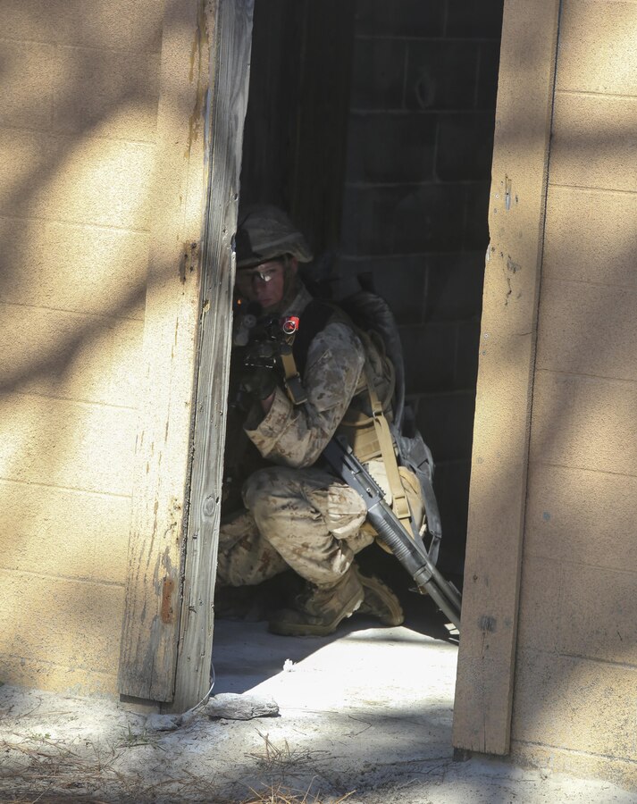 A Marine with Battalion Landing Team 2/6 provides security during a vertical assault raid training course at Combat Town aboard Marine Corps Base Camp Lejeune, N.C., March 31, 2015. The course is designed to teach Marines how to conduct military operations in urban terrain after being inserted by aircraft. The unit practiced patrolling, room clearing and casualty evacuation. (U.S. Marine Corps photo by Pfc. Dalton A. Precht/Released)