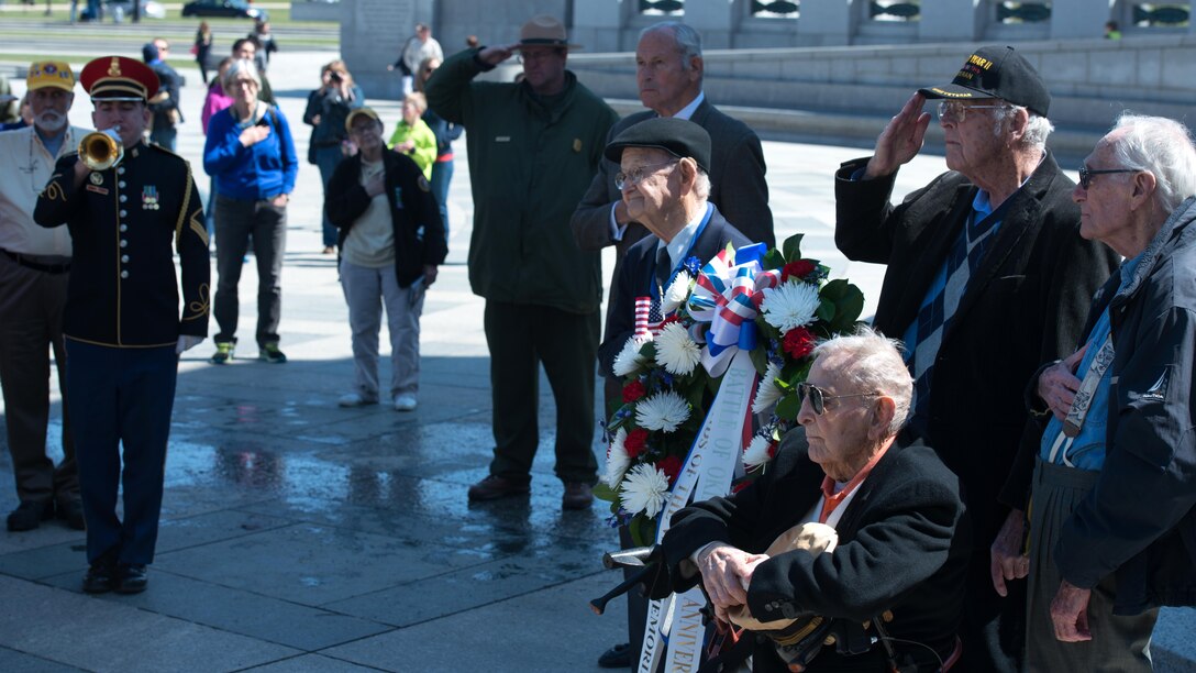 World War II veterans pay their respects for the service members, who participated in the Battle of Okinawa as Taps is played during a wreath laying ceremony at the World War II Memorial in Washington April 1, 2015. On April 1, 1945, allied forces invaded the island of Okinawa. The battle lasted 82 days amassing high totals of allied, Japanese and civilian casualties.