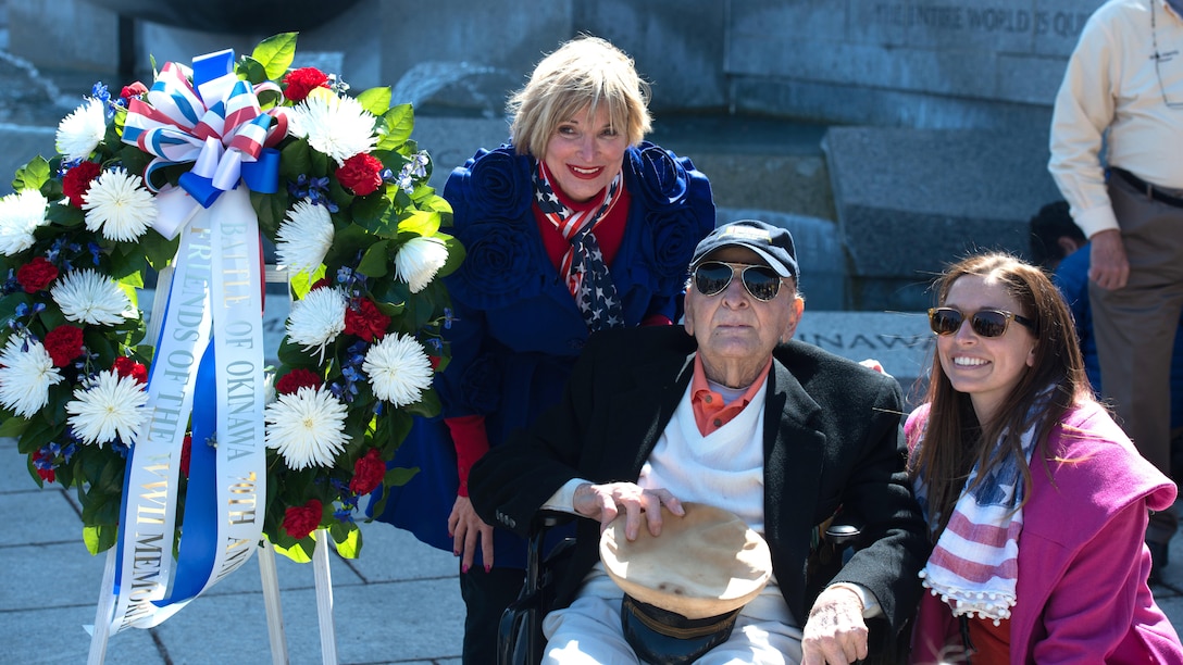 John ‘Jack’ Cassidy, World War II and Navy veteran and his family speak with the crowd before a wreath laying ceremony in honor of the 70th anniversary of the Battle of Okinawa at the World War II Memorial in Washington on April 1, 2015. On April 1, 1945, allied forces invaded the island of Okinawa. The battle lasted 82 days amassed high totals of allied, japanese and civilian casualties.