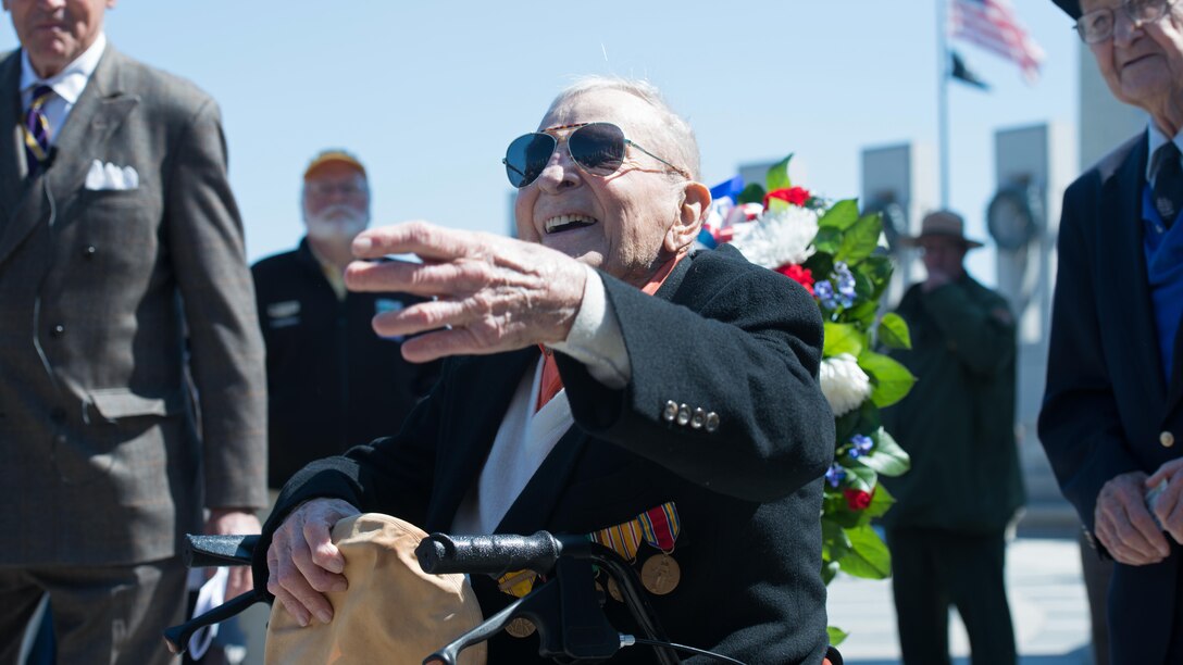 John ‘Jack’ Cassidy, World War II and Navy veteran reaches out to shake someone’s hand before a wreath laying ceremony in honor of the 70th anniversary of the Battle of Okinawa at the World War II Memorial in Washington D.C. on April 1, 2015. On April 1, 1945, allied forces invaded the island of Okinawa. The battle lasted 82 days amassed high totals of allied, japanese and civilian casualties.