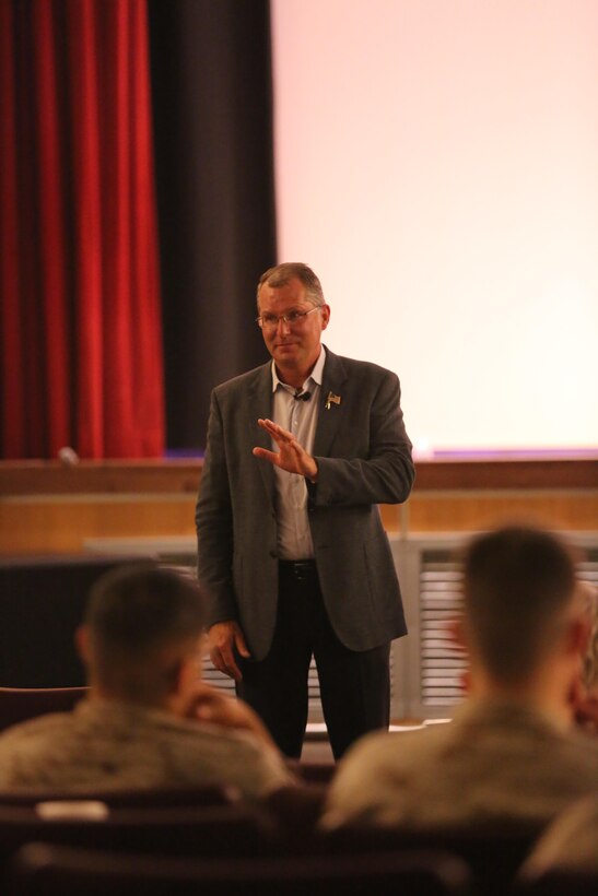Best-selling author Dave Pelzer speaks to a crowd of Marines, Sailors and civilians during a visit to Marine Corps Air Station Cherry Point, N.C., April 1, 2015. 