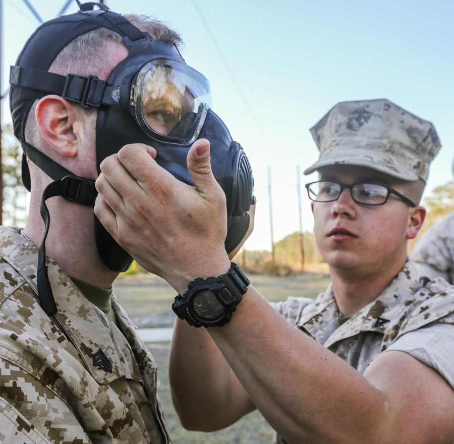 Lance Cpl. Morgan J. Flax (right) checks the seal of Sgt. Brett T. Morris’ (left) M80 Joint Service mask during the 26th Marine Expeditionary Unit’s annual certification at the gas chamber aboard Marine Corps Base Camp Lejeune, N.C., March 18, 2015. (U.S. Marine Corps photo by Cpl. Joshua W. Brown/Released)