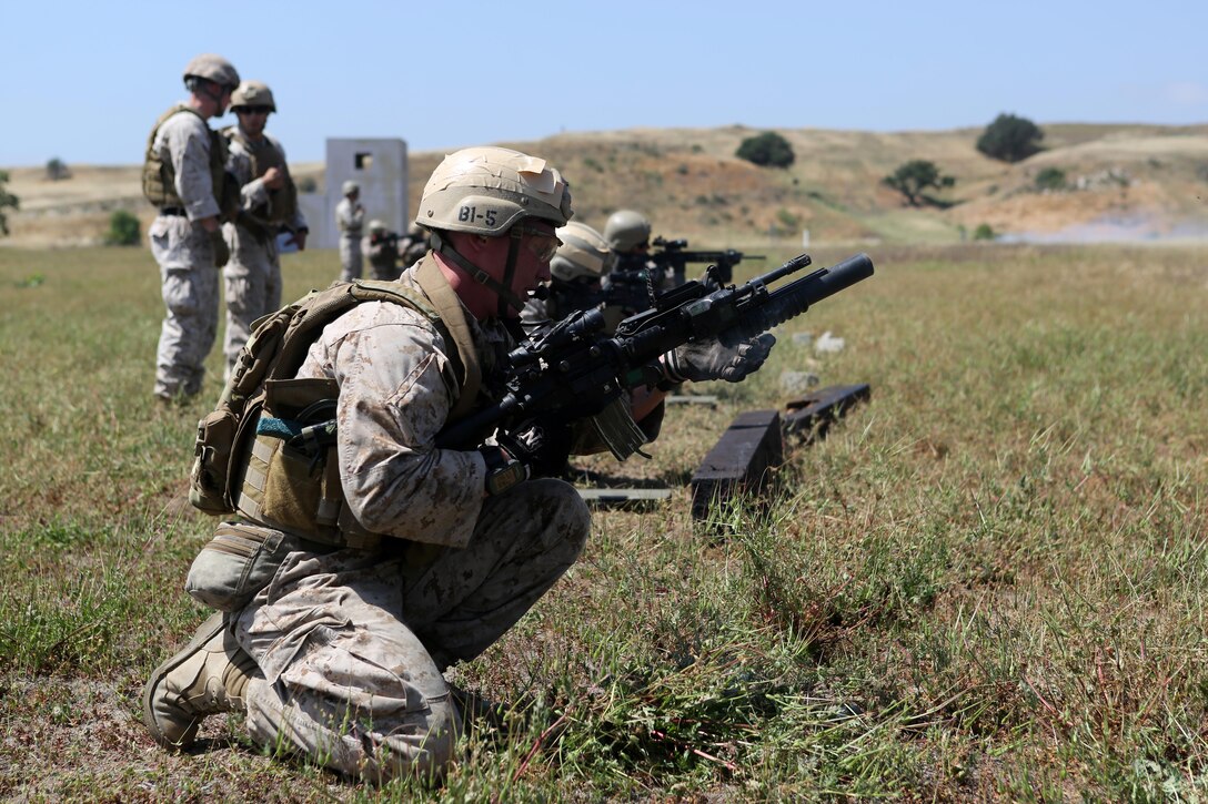 Sergeant Wesley Ferguson, assistant team leader, Charlie Company, 1st Reconnaissance Battalion, reloads an M203 grenade launcher during a live-fire raid at Range 226 aboard Camp Pendleton, Calif., April 1, 2015. Ferguson, a native of Lehi, Utah, and the company conducted the live-fire exercise as part of a predeployment workup in support of the 13th Marine Expeditionary Unit. (U.S. Marine Corps photo by Sgt. Joseph Scanlan / released)
