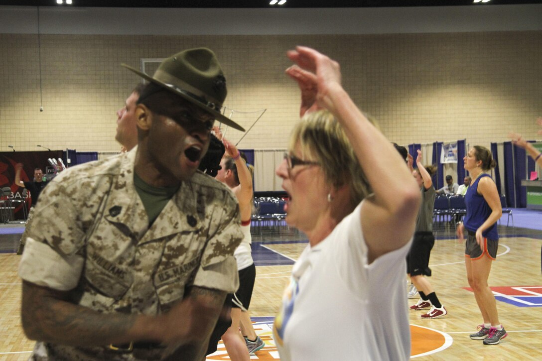 Marines take coaches through the coaches’ workout during the 2015 Women’s Basketball Coaches Association at the Tampa Convention Center, Tampa, Fla., April 5, 2015. The workout showed coaches the similarities between the Marine Corps and basketball such as team work, leadership and decision making.
