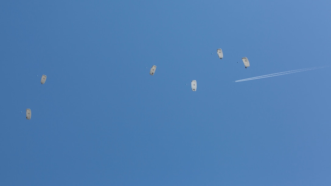 Teams of six Marines with 2nd Reconnaissance Battalion, 2nd Marine Division deploy their parachutes and descend to the landing zone together during monthly airborne jumps aboard Camp Lejeune, N.C., April 1, 2015. Conducting these routine jumps build the Marines’ confidence in their abilities as an individual and as a team member. 