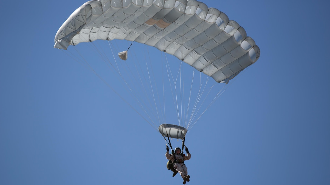 A Marine with 2nd Reconnaissance Battalion, 2nd Marine Division descends onto the landing zone during monthly airborne jumps aboard Camp Lejeune, N.C., April 1, 2015. This type of training is a building block that develops the Marines’ experience level allowing them to conduct mission-essential specialized airborne insertions. 