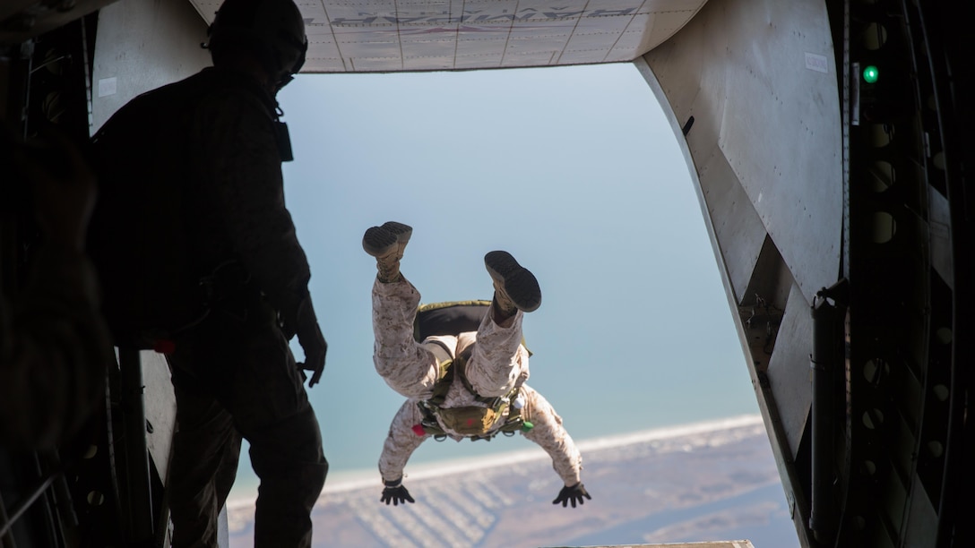 Sgt. Maj. Garritt E. Duncan with 2nd Reconnaissance Battalion, 2nd Marine Division jumps out the back of an aircraft during monthly airborne jumps aboard Camp Lejeune, N.C., April 1, 2015. Jumping at 12,500 feet above ground level, the Marines free-fall for about a minute before they release their parachutes near 5,000 feet and descend onto the landing zone. 