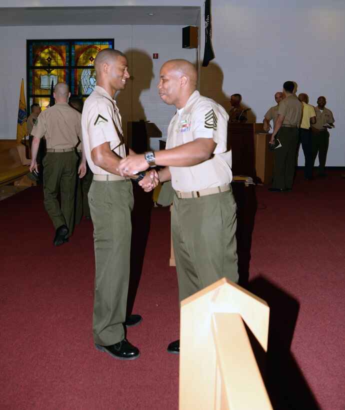 Lance Cpl. Alandre Brown congratulates Gunnery Sgt. Charles Kinsey after his retirement ceremony, April 3, at the Chapel of the Good Shepherd aboard Marine Corps Logistics Base Albany.
