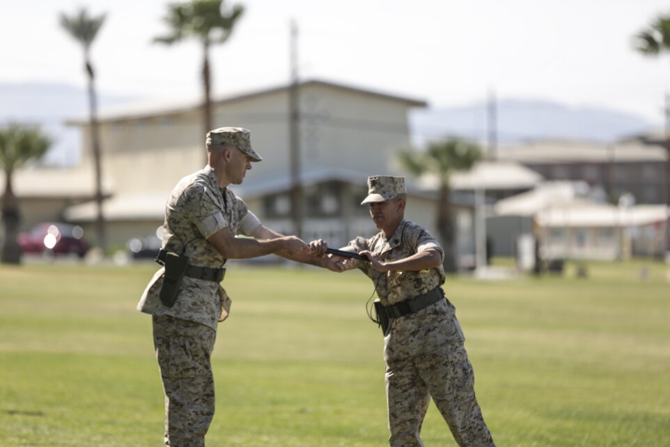 Lt. Col. Kain C. Anderson, commanding officer, Marine Unmanned Aerial Vehicle Squadron 1, passes the non-commissioned officer sword to Sgt. Maj. Avery L. Crespin during Crespin’s appointment ceremony at Lance Cpl. Torrey L. Gray Field, April 2, 2015. The sword represents a facet of military tradition and is entrusted to those who are responsible for maintaining it. (Official Marine Corps photo by Lance Cpl. Medina Ayala-Lo/Released)
